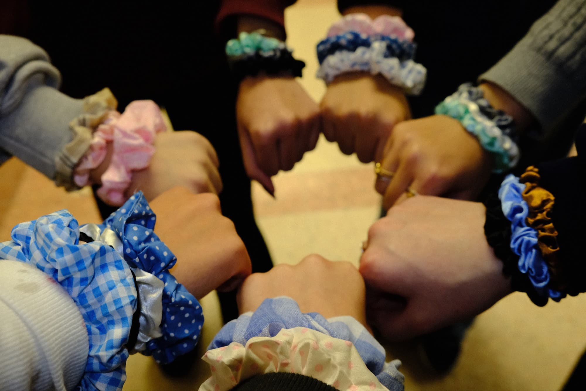 Scrunchies made from rescued fabric, stacked on a wrist